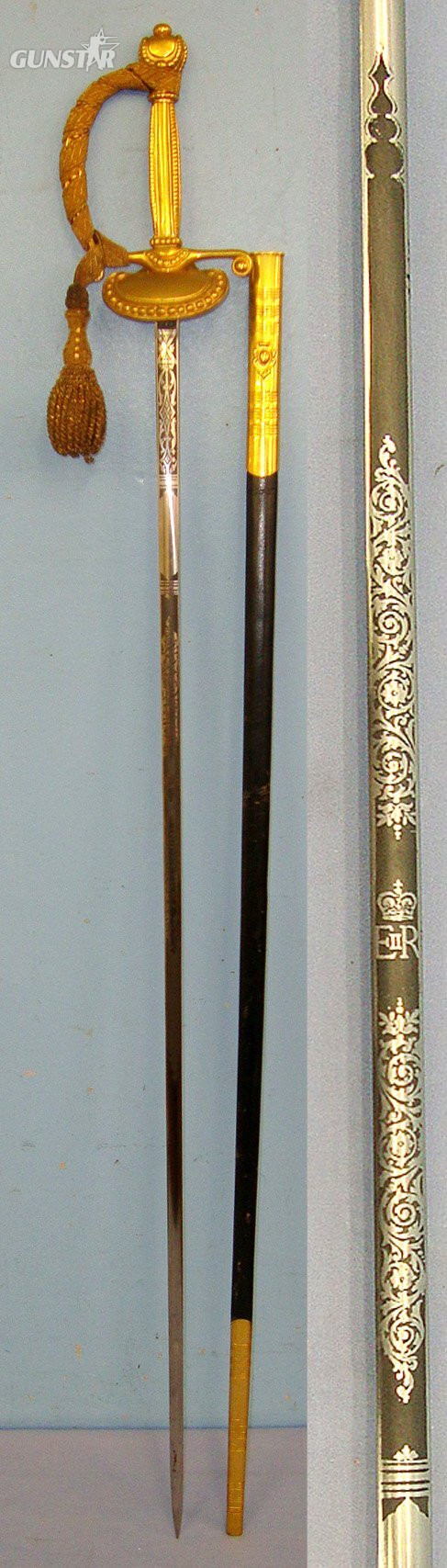 MINT**Post 1952 British Wilkinson Sword Ltd QE II Royal Household Clam Shell Court Sword With Blued & Etched Panels Blade, Gilt Hilt Fitted With Bullion Cord & Portepee & Scabbard. Sn 23573 Sword in 
