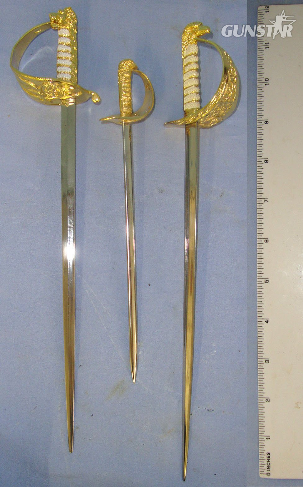  Collection Of 3 Boxed Mint Condition Miniature Swords: A British Royal Navy Officer’s By Nauticalia, A British Royal Air Force Officer’s Sword By Wilkinson & A British Royal Air Force Officer’s Sword By Nauticalia Each With Original Information Leaf Sword
