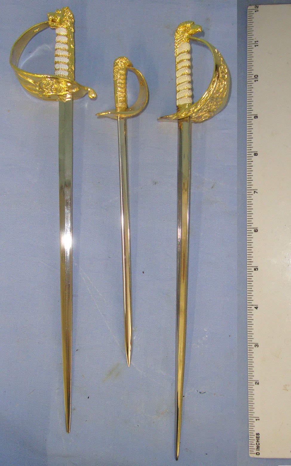  Collection Of 3 Boxed Mint Condition Miniature Swords: A British Royal Navy Officer’s By Nauticalia, A British Royal Air Force Officer’s Sword By Wilkinson & A British Royal Air Force Officer’s Sword By Nauticalia Each With Original Information Leaf Sword