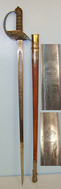 George V British Robert Mole & Sons Birmingham Makers To The War & India Offices 1897 Pattern Infantry Officer’s Sword To ‘A.A. Harrison 4th Battalion Manchester Regiment’ With Etched Blade Number 6581 & Leather Field Covered Scabbard Sword