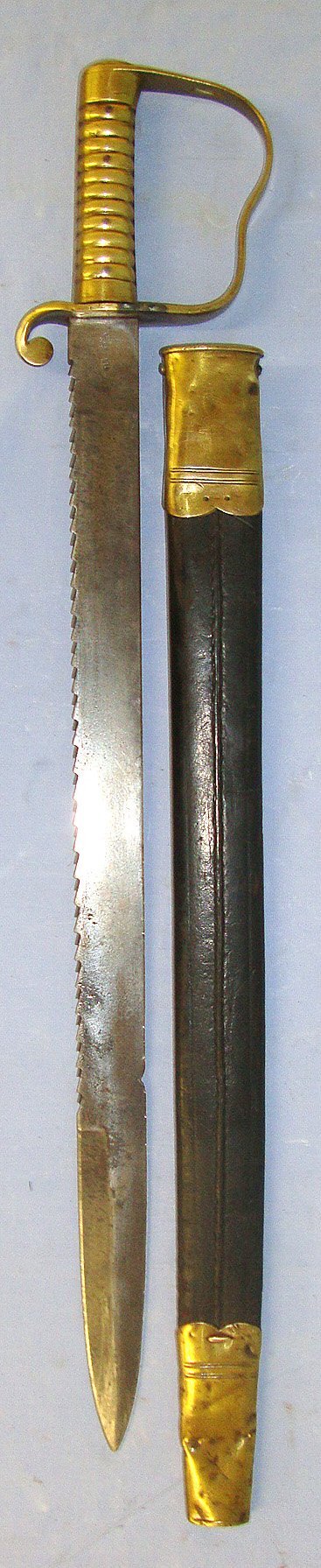  British WD 1856 Pattern Pioneer’s Sawback Short Sword Sidearm With Brass Hilt Regiment Marked ‘V MX 16 13’ To The Duke Of Cambridge’s Own (Middlesex Regiment) Volunteers & 1895 Scabbard Regiment Marked ‘3 DF 1’ To The Royal Dublin Fusiliers. S Sword