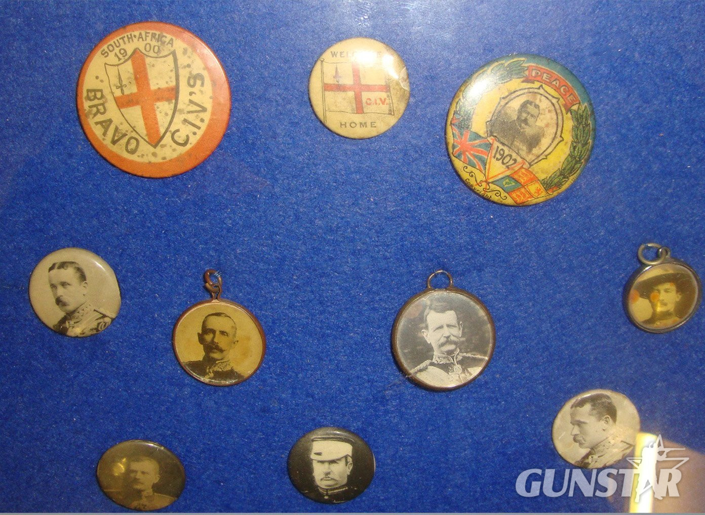 A Framed Collection Of Original Colourful Victorian Boer War Home Front / Recruitment / Propaganda Celluloid Wrapped Tin Pin Badges & Pendants. MISC 1014 - MISC 1014 A Framed Collection Of Original Colourful Victorian Boer War Home Front / Recruitment / Propaganda Celluloid Wrapped Tin Pin Badges & Pendants. MISC 1014 - MISC 1014 Antique & Militaria