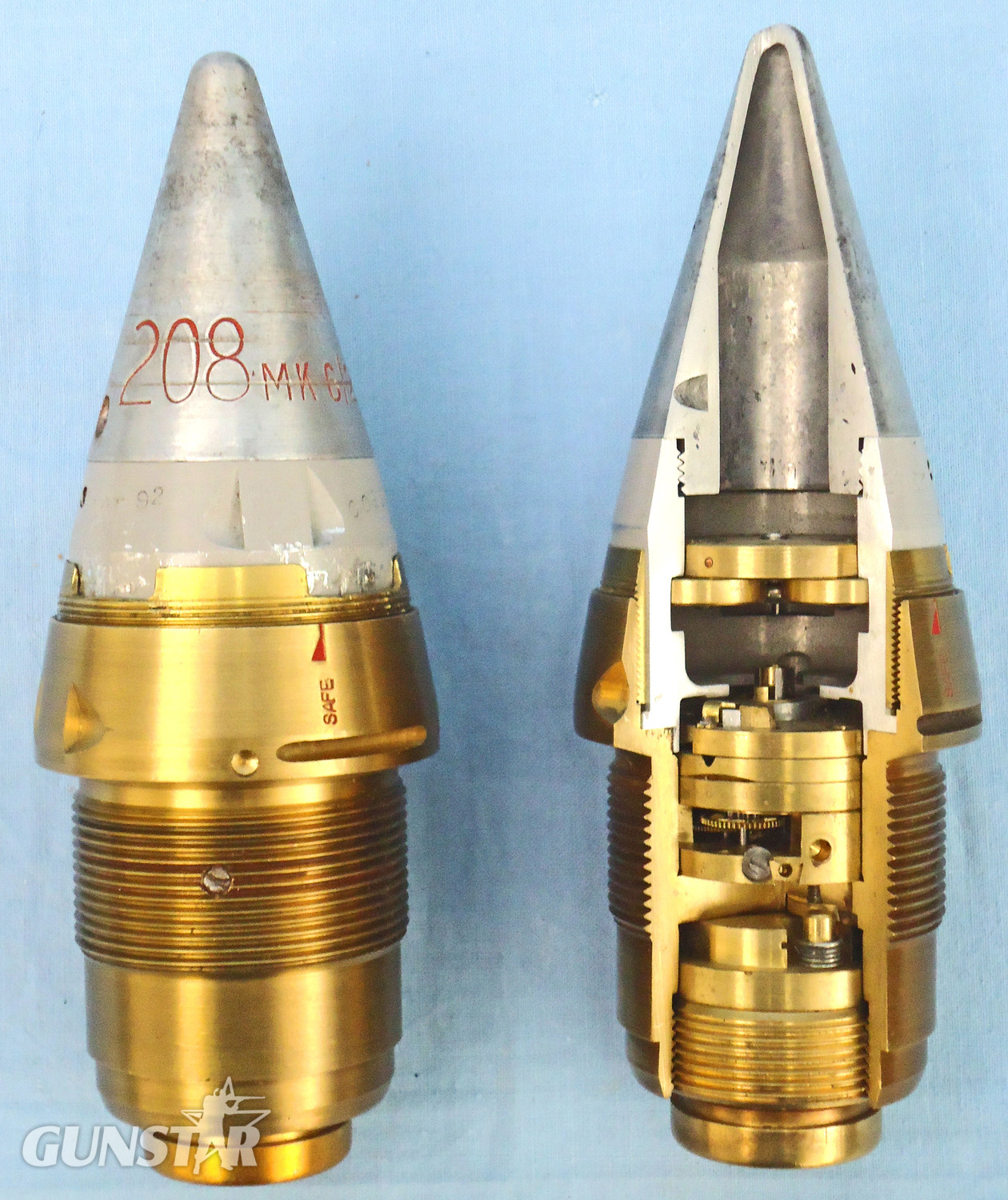  INERT. Pair Of Unfired British No 208 Mk 6/2 Clockwork Fuzes Converted To No 208 Mk 8/1 Fuzes. One In A Quarter Section & One Unsectioned For The British 3.7, 4.5 & 5.25 Inch Anti-aircraft Gun. Inch Anti-aircraft Guns On A Mahogany Display Plinth. - O 195 INERT. Pair Of Unfired British No 208 Mk 6/2 Clockwork Fuzes Converted To No 208 Mk 8/1 Fuzes. One In A Quarter Section & One Unsectioned For The British 3.7, 4.5 & 5.25 Inch Anti-aircraft Gun. Inch Anti-aircraft Guns On A Mahogany Display Plinth. - O 195  Other Ammunition