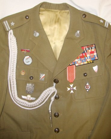 C1960 Cold War Era Polish Officers Uniform Complete with Order of Polonia Restituta Medal, Enamelled Insignia, Ribbons and Cord Aiguillette with Silver Plated Tag. Sn 6953. C1960 Cold War Era Polish Officers Uniform Complete with Order of Polonia Restituta Medal, Enamelled Insignia, Ribbons and Cord Aiguillette with Silver Plated Tag. Sn 6953.  Clothing