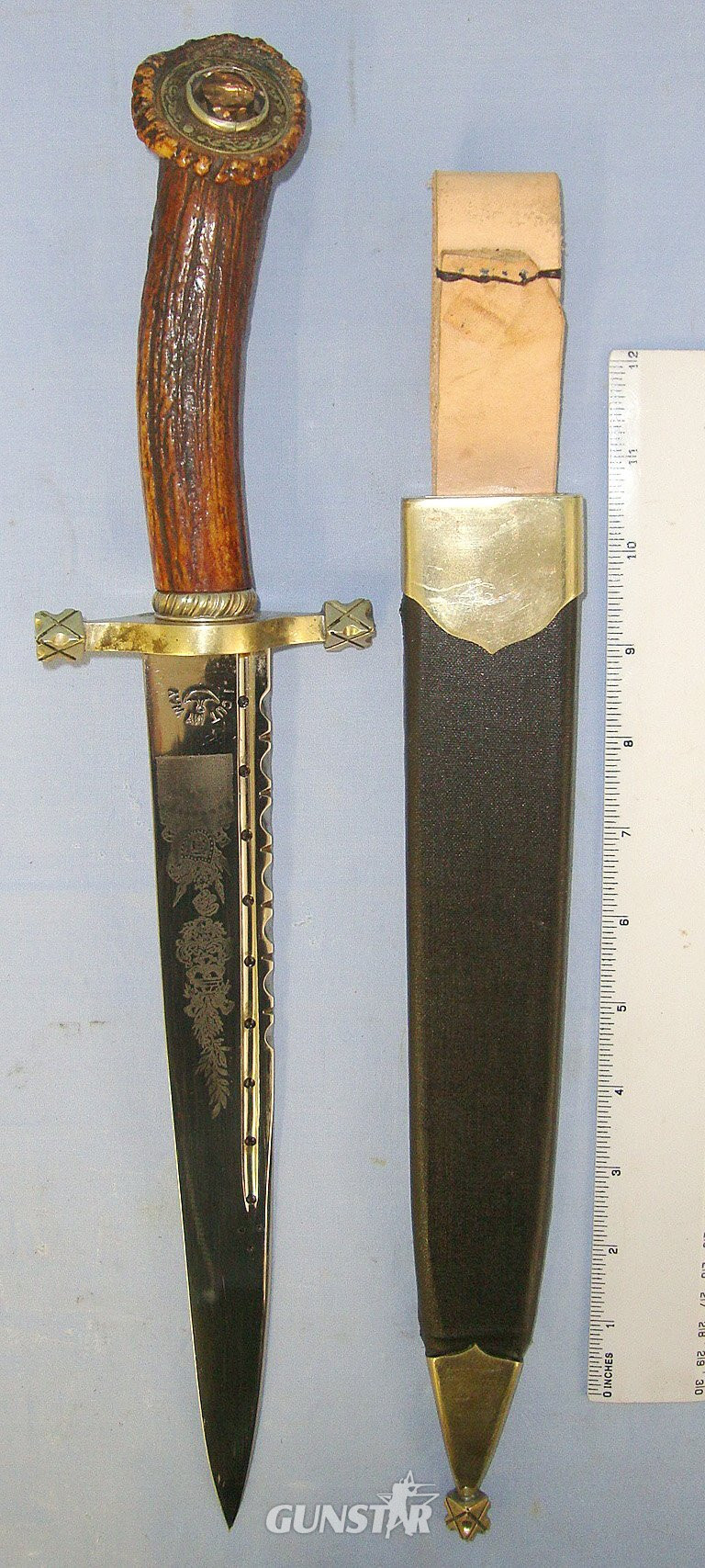 C1950’s Large William Rodgers ‘I Cut My Way’ Sheffield Scottish Highlander's Hunting Dirk Form Spear Point Bowie Knife With One Piece Deer Antler Hilt 'Cairngorm' Jewel Setting, Etched Blade & Leather Covered Wood Scabbard With Brass Mounts. Sn 2350 Knive in 