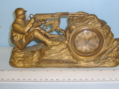 WW1 French E.Richer Editeur Paris Depose Trench Art Mantelpiece or Desk Clock Featuring A Model 1914 Hotchkiss Machine Gun Emplacement This is an attractive original pot metal trench art clock. The fully working clock with brass rimmed 2” glazed face is in working order and has its original winder. The clock is bolted into a well formed gilt finished pot metal trench combat scene depic Other Accessory