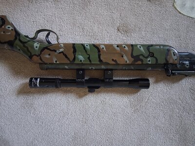 Unknown Camoflage rifle with scope  .22