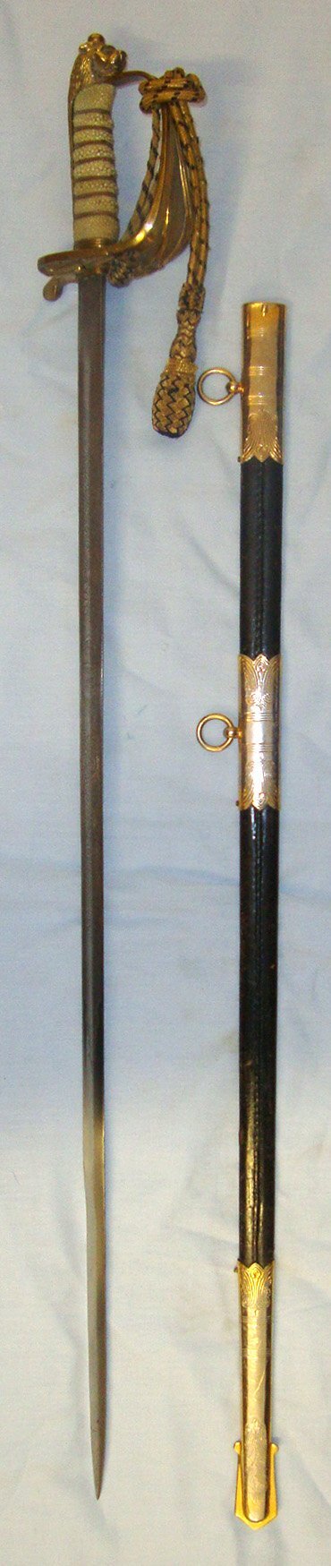  Post 1952 QE II British WD Pattern 1827 Wilkinson Sword Royal Navy Officer’s Sword With Etched Blade Bullion Cord, Portepee and Scabbard. Sn 22120 Sword