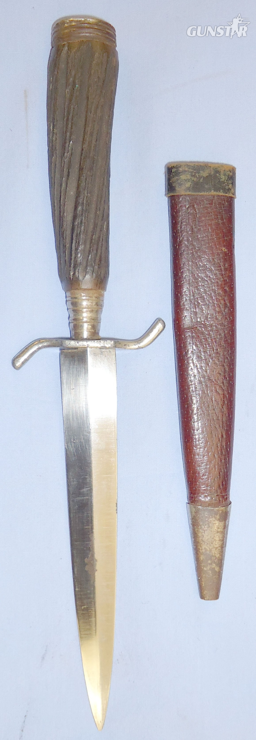 A nice original WWI German trench/fighting knife and steel scabbard. The knife is a hunting style variant and features a carved wood simulated stag-horn hilt (see page 40, plate 177 of Steven\'s book \'Fighting Knives\'). The dagger has a German silver po Dagger in 
