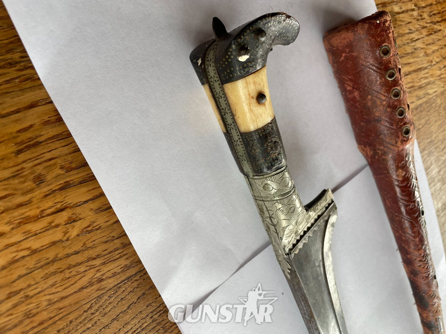 TRADITIONAL PASHTUN TRIBUTE KNIFE    YAK HORN AND BONE HANDLE    SILVER GUARD AND BUCKLE  TYPICAL T-SHAPED BLADE   TOTAL LENGTH: 35 CM  TRADITIONAL METAL AND LEATHER SHEATH Dagger