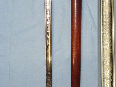 WW1 Era British WD 1897 Pattern Henry Wilkinson London Infantry Officer’s Sword With King George V Guard, Etched Blade Number 45529, Leather Officer’s Cord & Acorn Knot Leather Covered Field Service Scabbard & Sam Browne Leather Frog Without Long Stra Sword