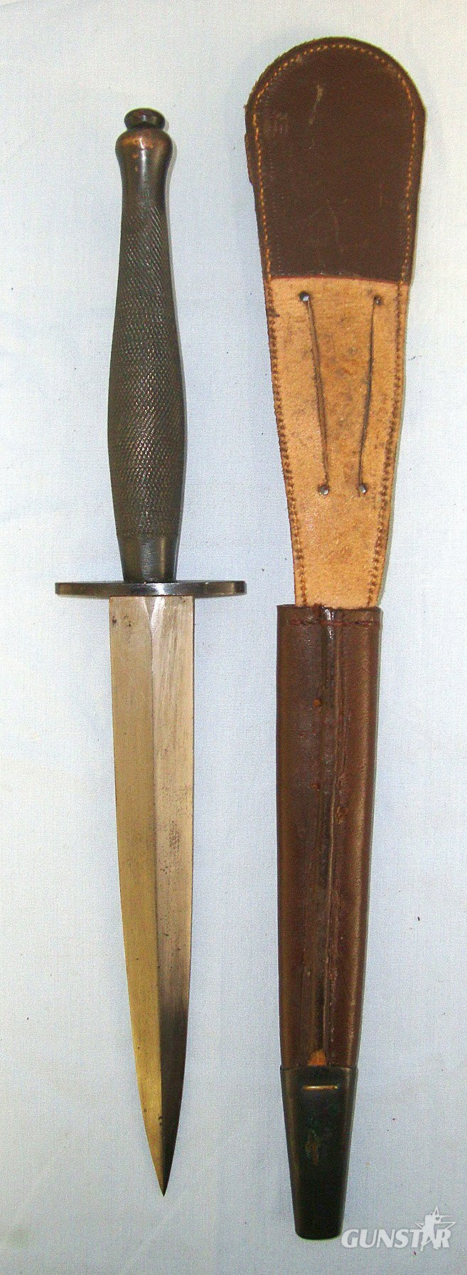 ONE OF THE RAREST**WW2 British 2nd Pattern Fairbairn Sykes FS Commando Fighting Knife By Wilkinson Retailed By J & I Marshall Glasgow Scotland With Etched Panel And Hand Drawn Blade Complete With Scabbard. Sn 23579 Knive