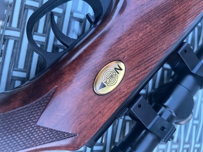 Norica Norica .22 break-barrel air rifle with hardwood stock and telescopic sight. Good overall condition with only minor cosmetic marks from normal use. Fitted with fiber-optic open sights and scope. Cocks and fires correctly. Ideal for target shooting and pest .22