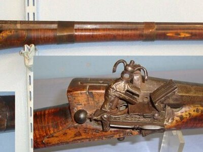 19th Century Ottoman Empire 24 Bore Miquelet Lock Rifle With Octagonal Barrel, Tiger Stripe Olive Or Palm Wood Stock, Silvered Hand Tooled Decoration, Action & Barrel Arabic Gunsmith / Family Signatures & Ram Rod. Sn 15226 Muzzleloader None Rifle